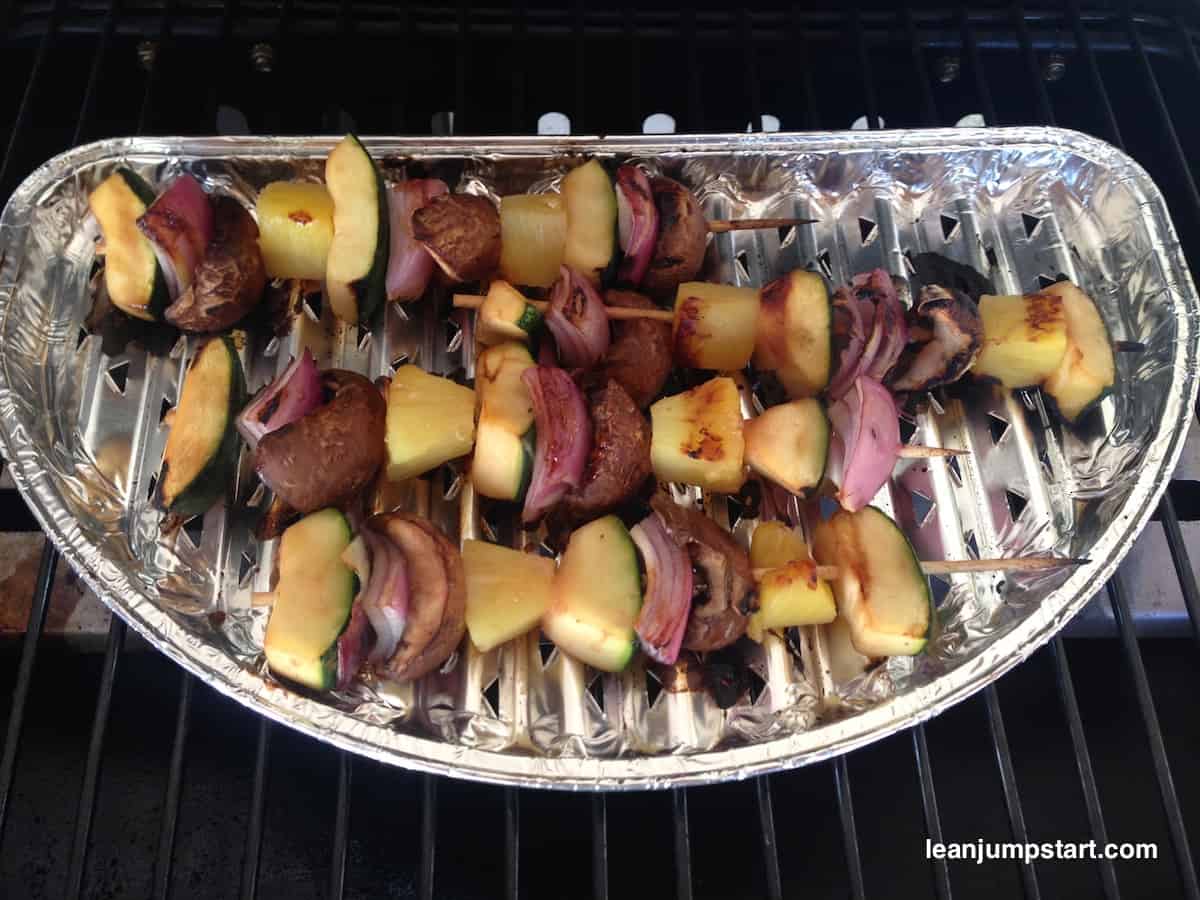 grilled kabobs on aluminum plate placed on a grill