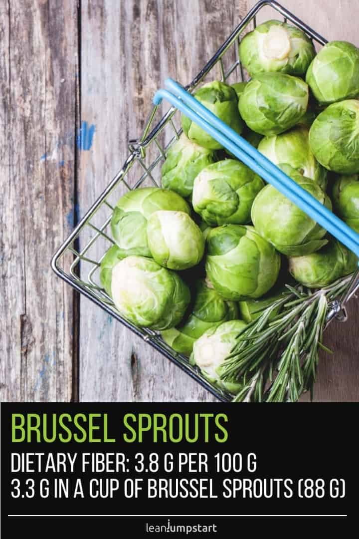 brussel sprouts in a metal basket on wood