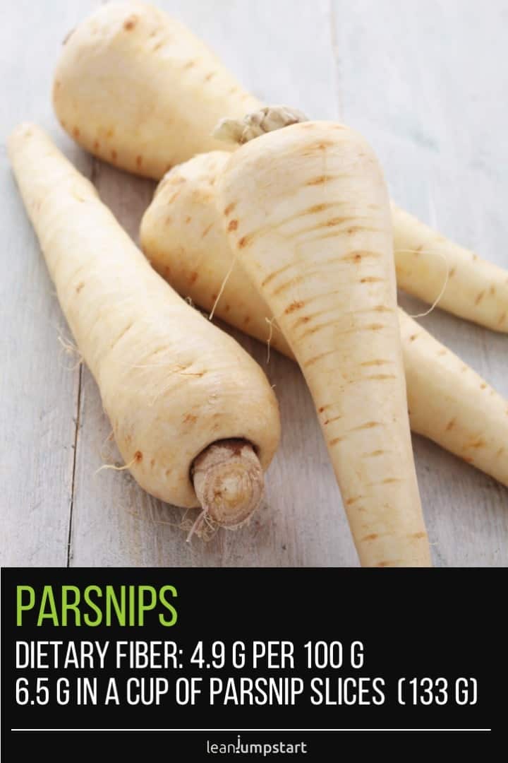 four parsnip roots on a wooden table