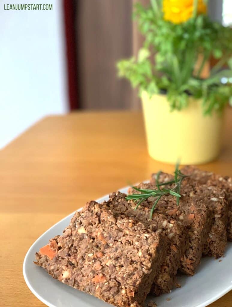 several lentil loaf slices with a yellow flower in the background