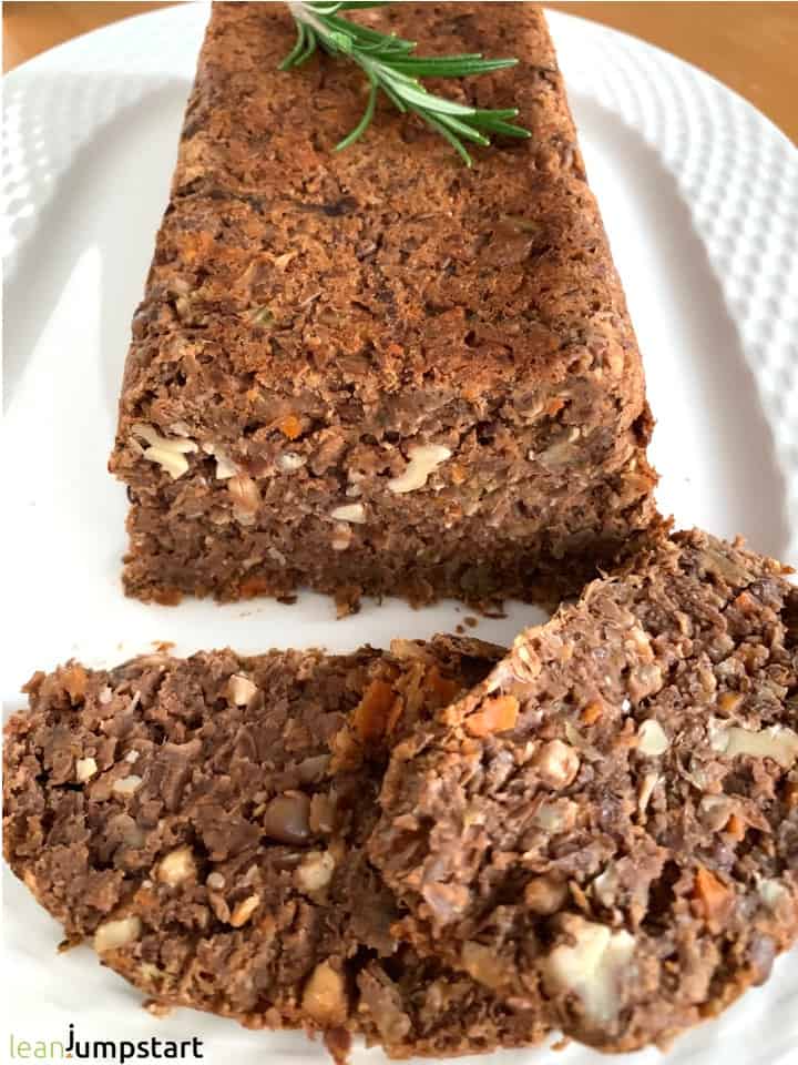 whole vegan lentil loaf with two slices in front