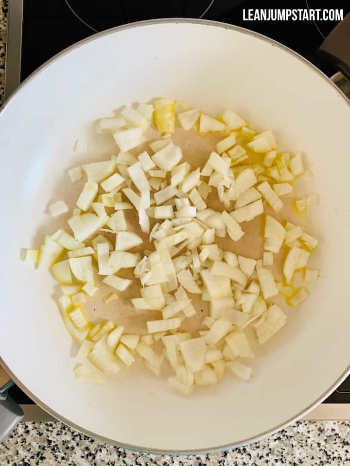 diced onions sautéing in a pan